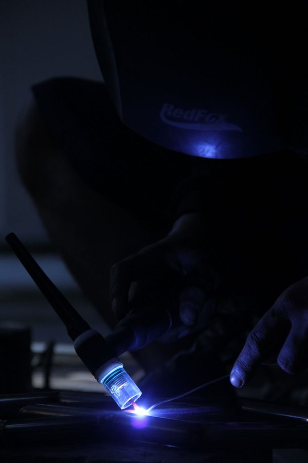 Workshop fabrication showing metalworker at anvil